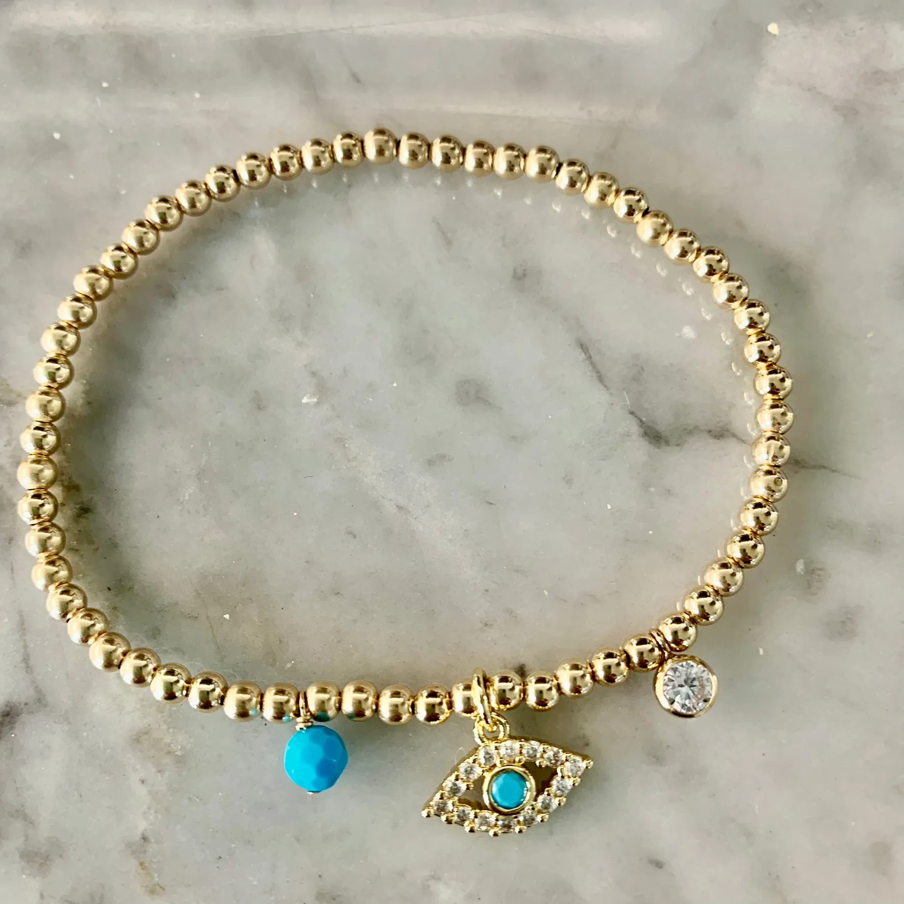 3mm Bead Stretch Bracelet with Matching Eye, CZ Bezel, and Turquoise Charms