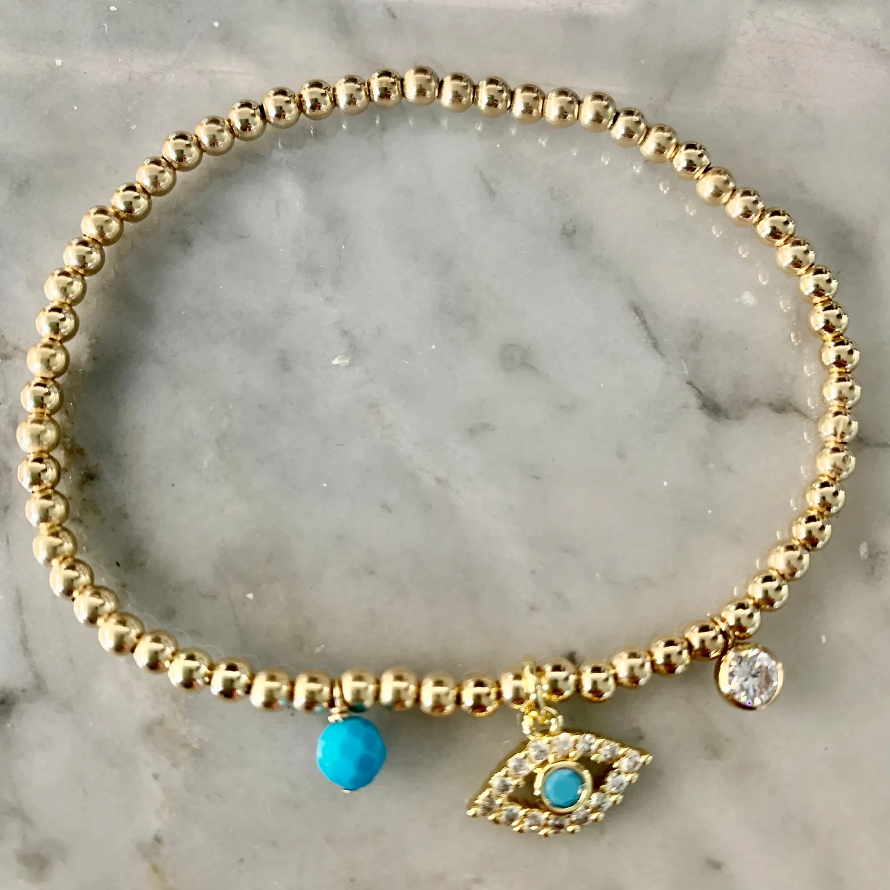 3mm Bead Stretch Bracelet with Matching Eye, CZ Bezel, and Turquoise Charms