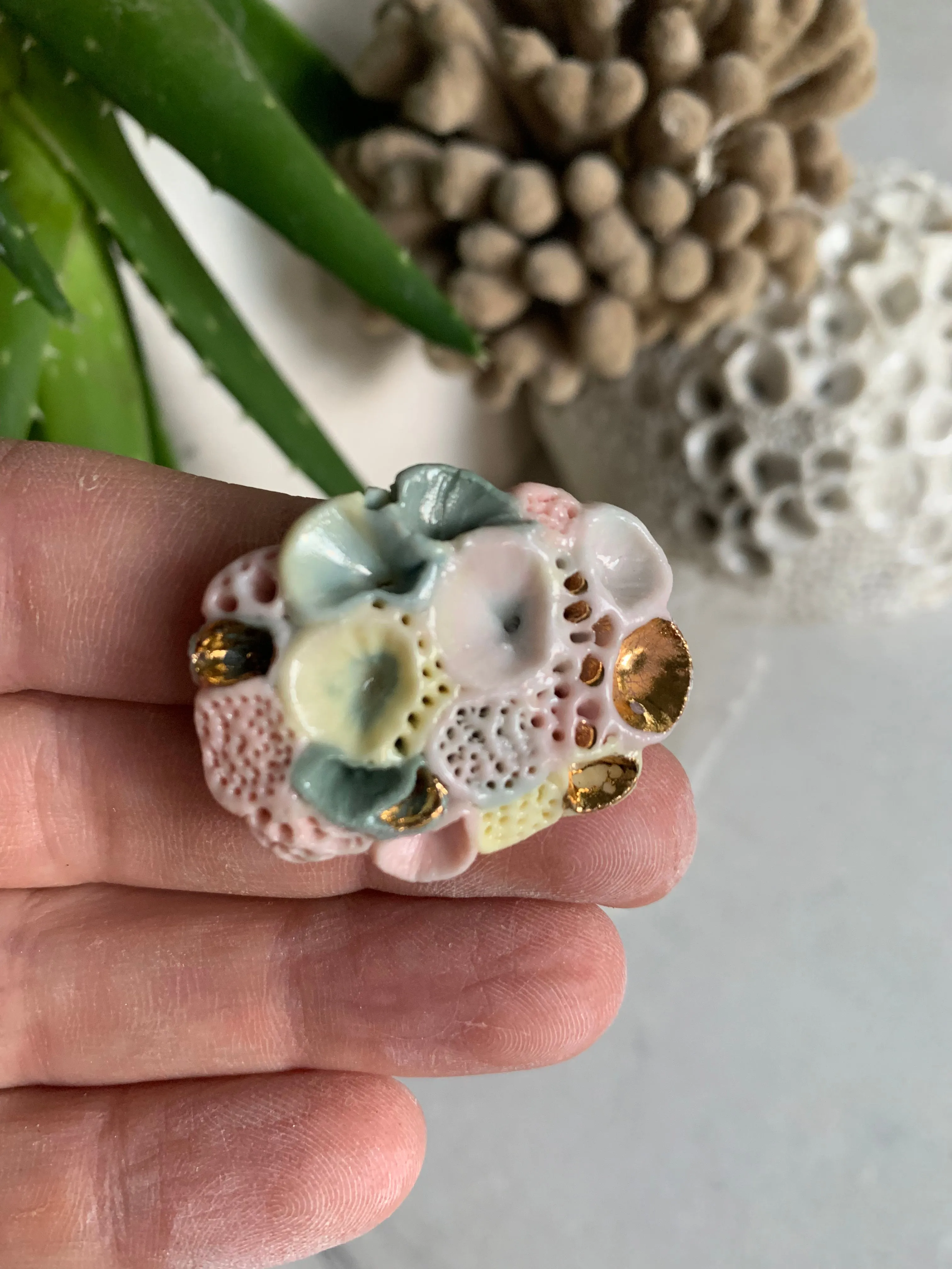 Copy o’Rock coral’ coloured porcelain brooch, choose one